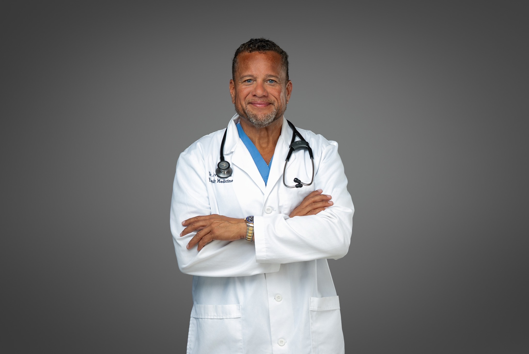 M. Christopher Aviles, MD in a white coat